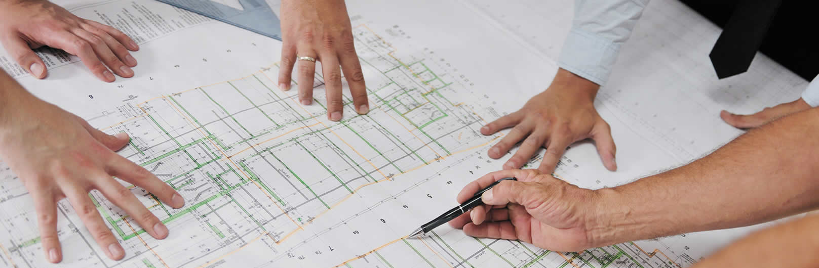 Consulting Engineers with pencils looking over a drawing